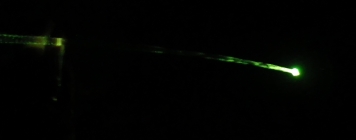 Stream of Illuminated Water Lit by RGB LED During a Test in a Dark Space